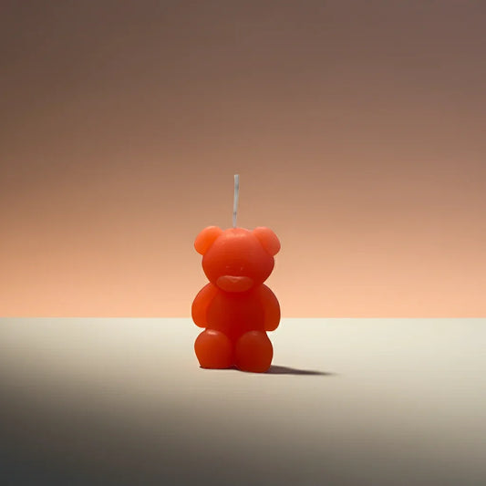 Handgemachte Kerze in Bärenform, orange, dekorativ und nachhaltig, auf hellem Hintergrund